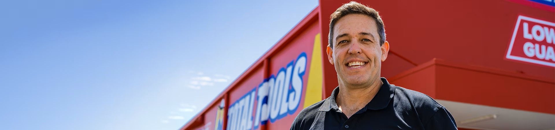 Mark Timbs from Total Tools smiling outside one of his stores