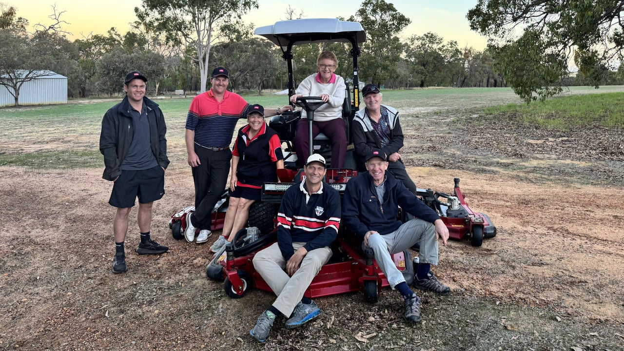 A group shot of members of the Danadaragan Golf Club with their new mower.