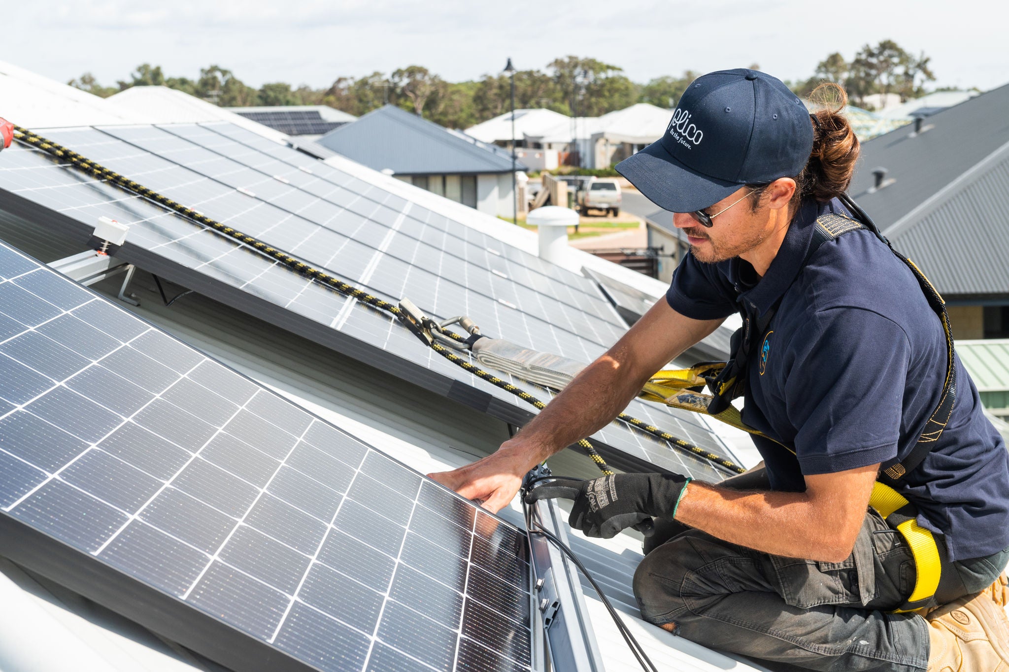Close up of Plico solar installer on a roof fitting solar panels