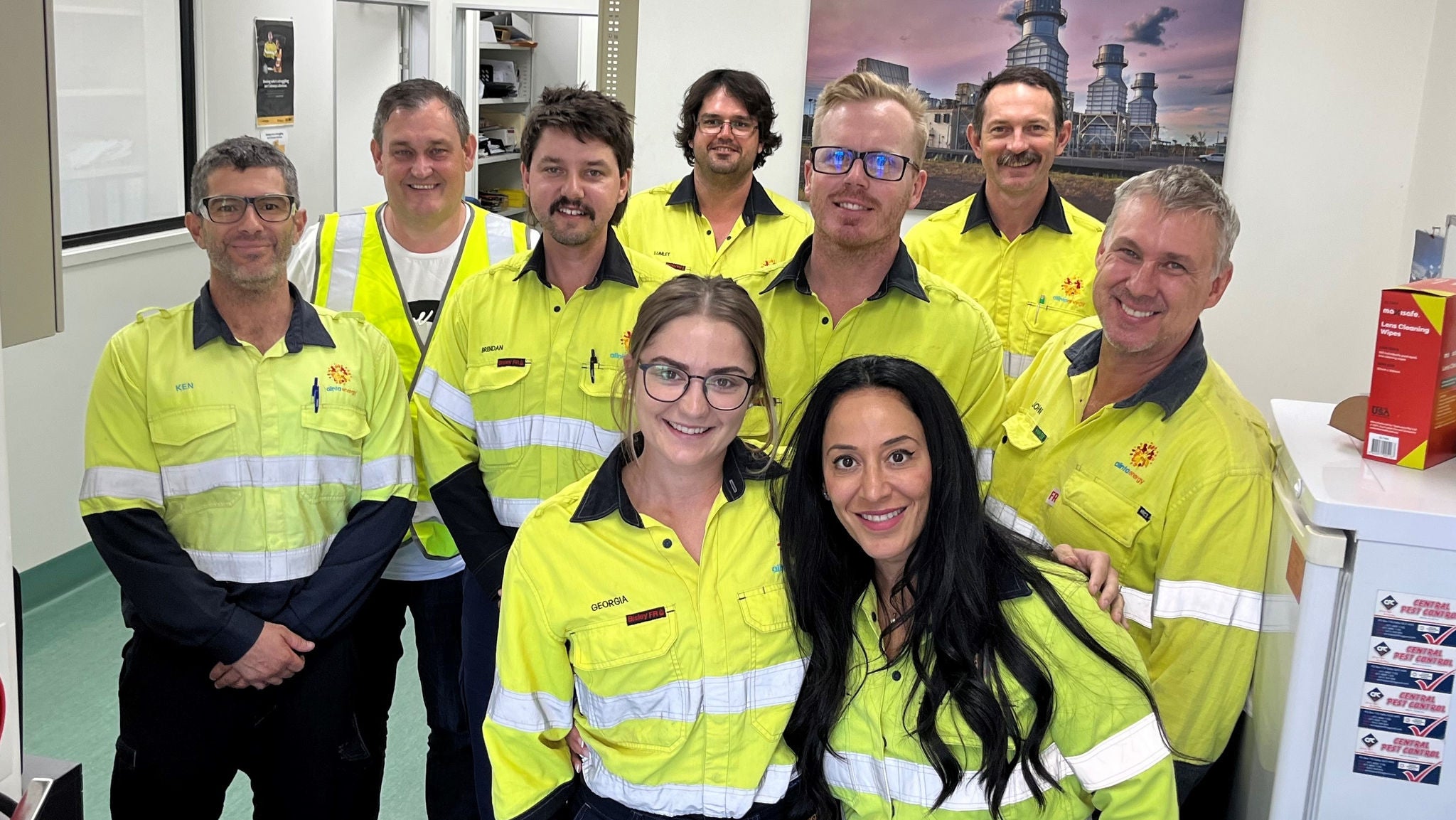 A group photo of the Braemar team in yellow hi-vis clothing.