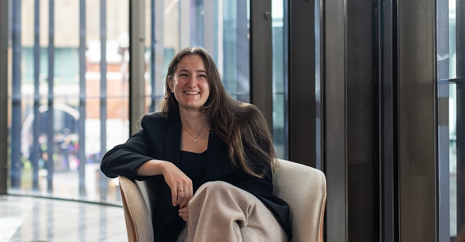 Smiling graduate sitting in a chair in the Alinta Energy office