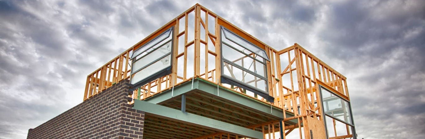 New house being built showing wooden frame and bricks