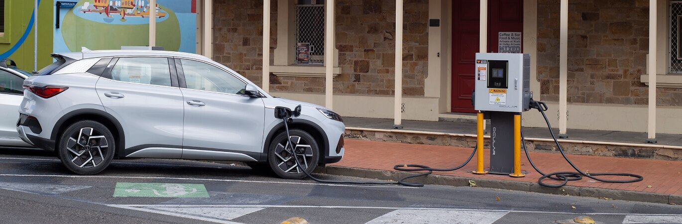White EV parked at charging point in Port Adelaide, SA
