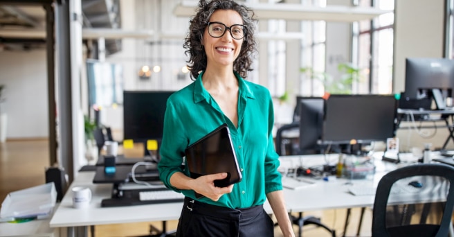 Woman wearing glasses in office smiling