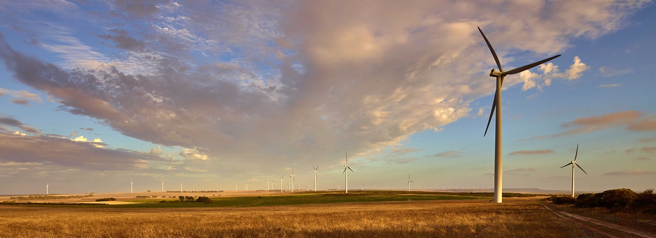 A wind turbine pictured against a blue sky