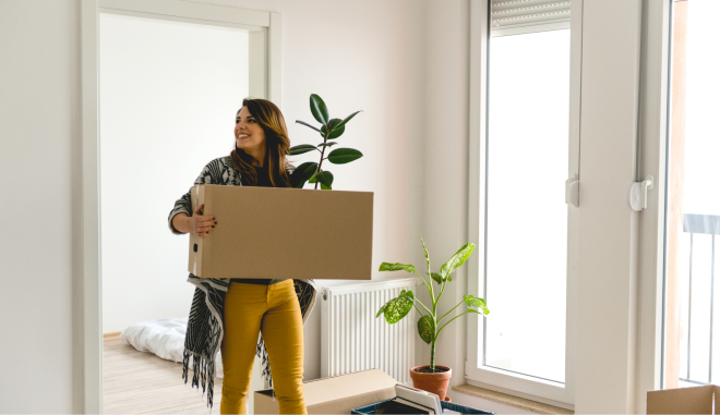 Woman carrying large cardboard box