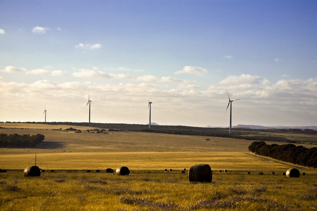 Wind Farm with hay bales at sunset