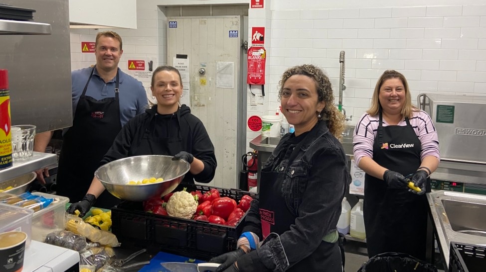 Volunteers from Alinta Energy prepping a Salvos lunch