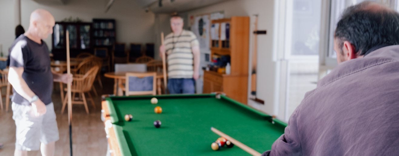 Servants residents play pool together