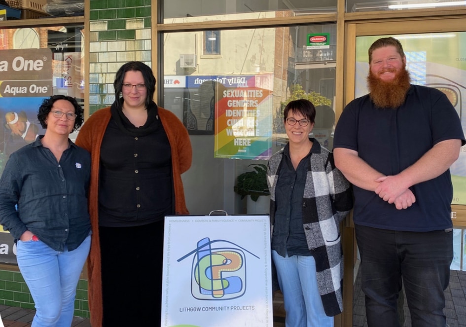 Smiling volunteers at Lithgow Community Projects outside of a store front