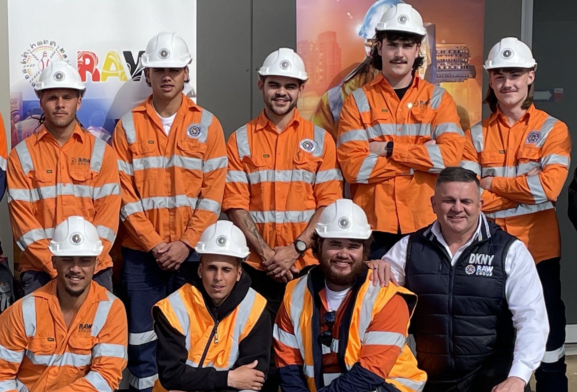 An image of the SAABCCA workers in hi-vis and hard hats with Allan Jones.