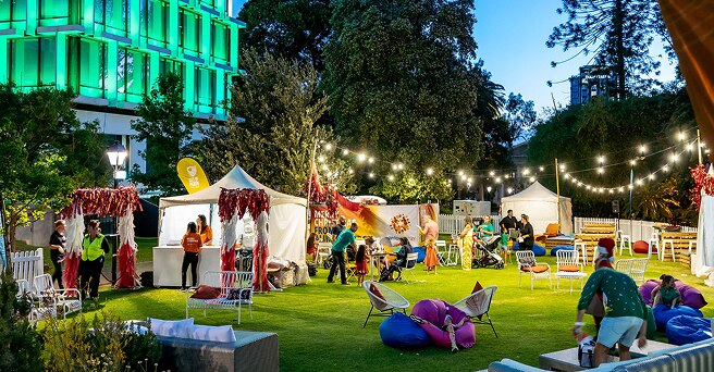 The VIP Experience area of the Alinta Energy Christmas pageant showing bright festoon lighting and tents