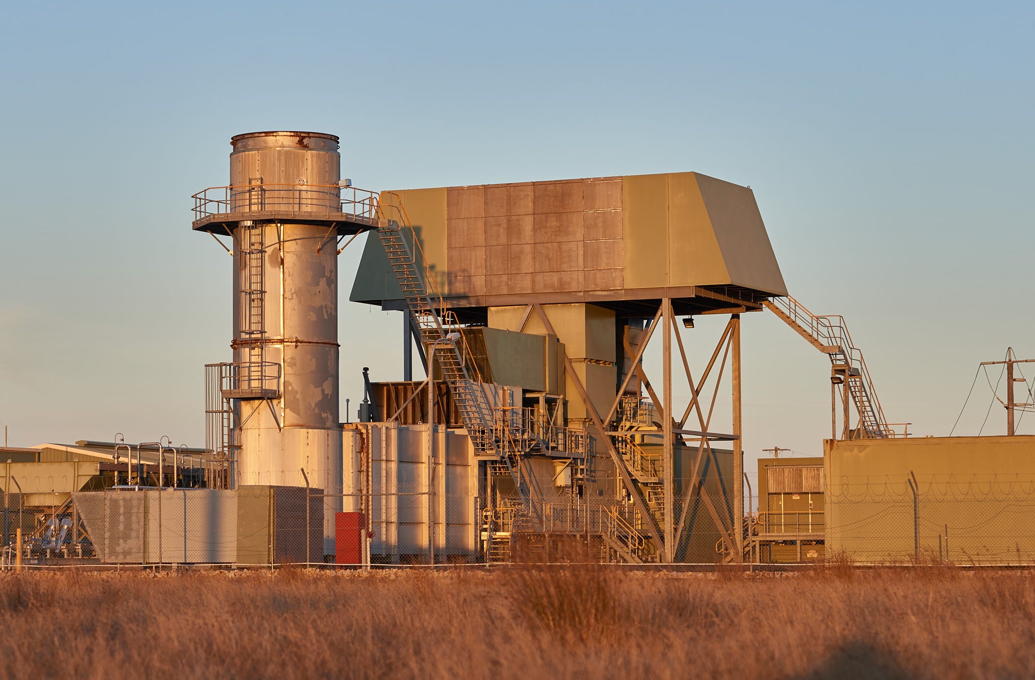 Bairnsdale Power Station in the late afternoon, surrounded by tall brown grasses