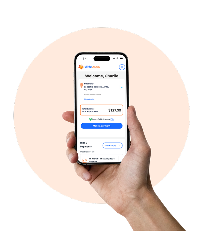 Closeup of hand holding up mobile phone with screen showing payment page on Alinta Energy's MyAccount app
